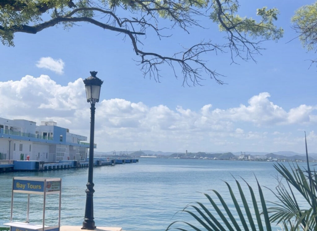 Bay in Old San Juan, Puerto Rico, featuring historic buildings in the background and scenic views of the surrounding mountains