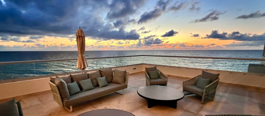 Sunrise over the Caribbean viewed from a second-level sitting area at Sun Palace Cancun, offering a peaceful and picturesque setting.