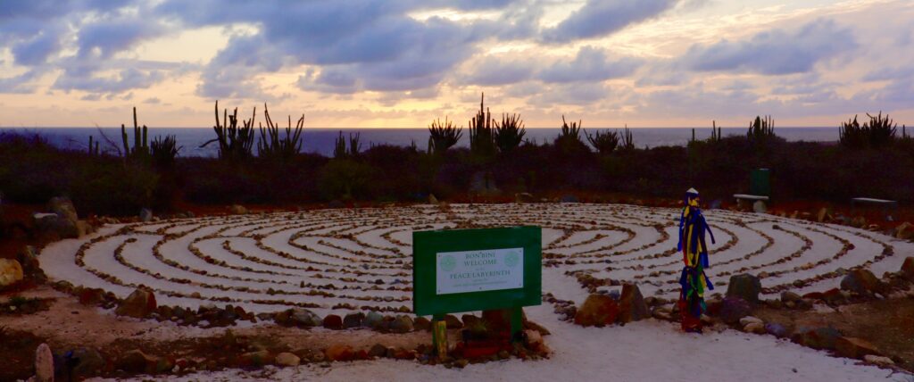 Labyrinth at Alto Vista Chapel site in Aruba, surrounded by cacti and with sunrise in the background, offering a peaceful and serene setting