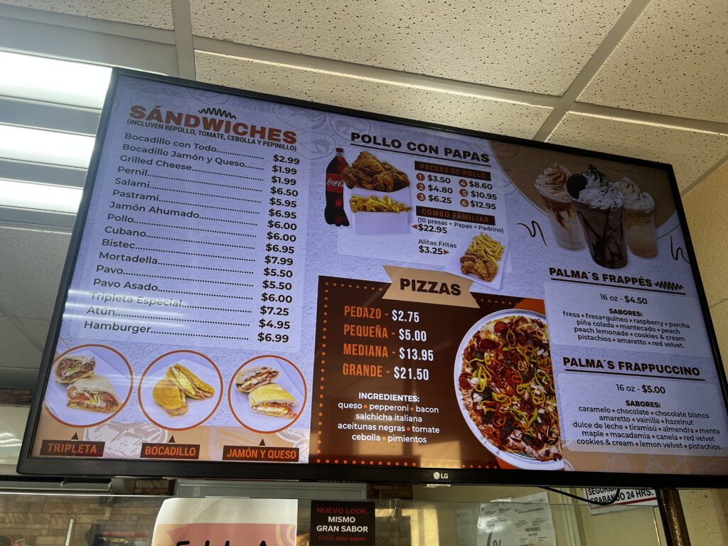 Menu inside Palmas Bakery in Puerto Rico with a variety of baked goods and affordable prices displayed