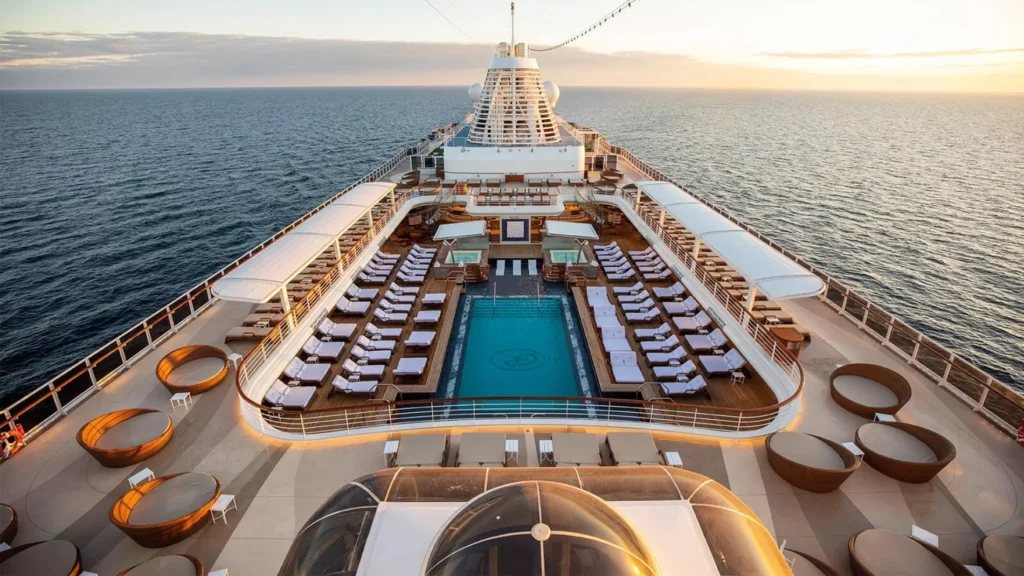 Sky Deck on Regent Seven Seas cruise ship featuring a luxurious pool at the center, surrounded by comfortable lounge areas and stunning ocean views, creating a serene and upscale atmosphere