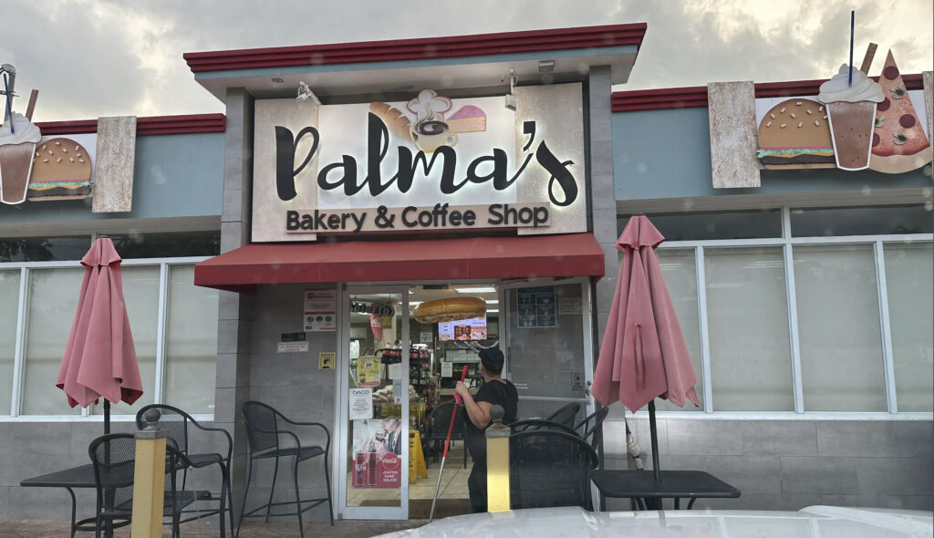 Exterior view of Palmas Bakery in Puerto Rico, showcasing the charming storefront with baked goods and a welcoming atmosphere.