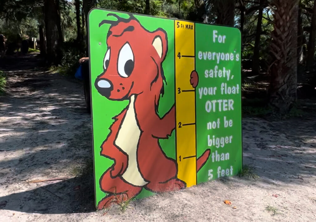 Sign at Kelly Park Rock Springs featuring an otter illustration and ruler with the message 'For Everyone’s Safety, Your Float Cannot Be Bigger Than 5 Feet